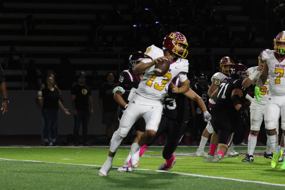 Koa Regalado races out of the pocket against Fontana High's defense. The Steelers struggled to contain the quarterback in the first league game of the season.