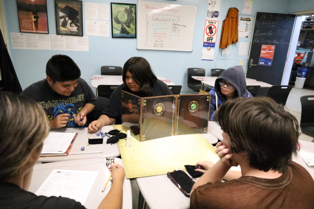 D&D Club charter members Erik Cruz and Jayden Camacho review the dice from a turn during their most recent campaign with new members Nam Hoang, Cosmo Mosher-Dominguez and Valerie Pacheco.