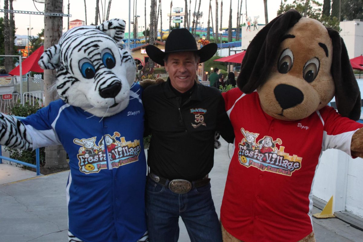 Fiesta Villages mascots Bogey and Slugger link arms with one of the Fiesta Village owners Patrick O'Brien