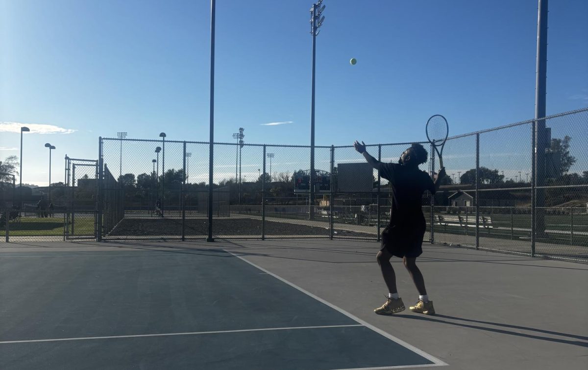 Team Captain Ja'len Terry serves during one of his three wins against Linfield Christian on Feb. 19.