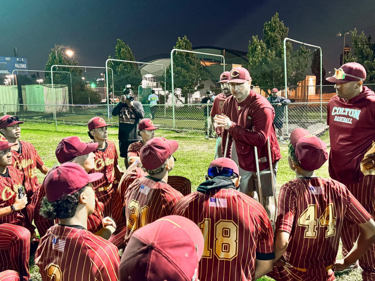 After the game, manager Mike Reh addresses the team. His arrival at the game late in the fifth inning sparked an 11-run offensive explosion in the sixth and seventh innings.