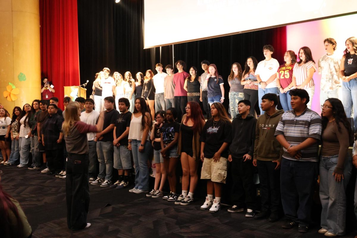 Dr. Jessica Cannaday leads the CHS choir in a performance of the school's alma mater at the end of the assembly.