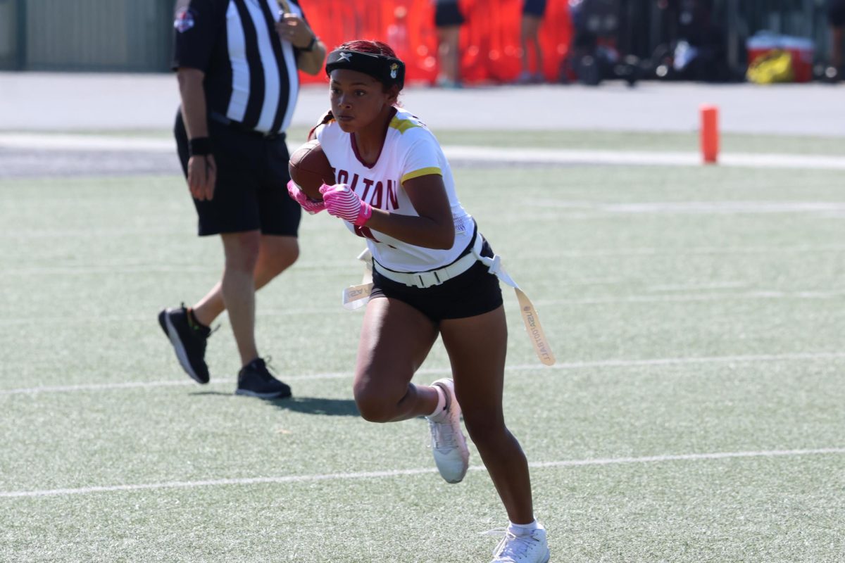 Madison Page sprints out of the pocket to run for a short gain.