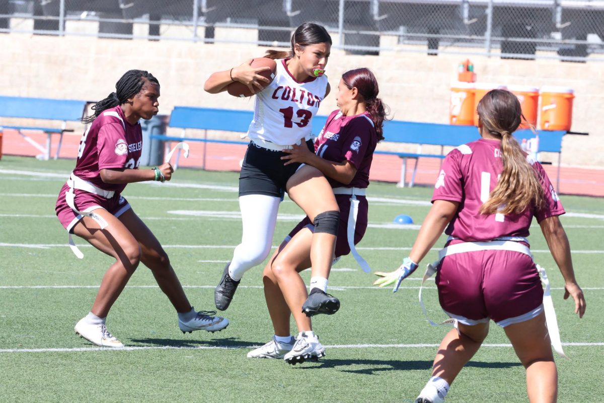 Quarterback Myiah Quezada pushes through the Steelers defense.