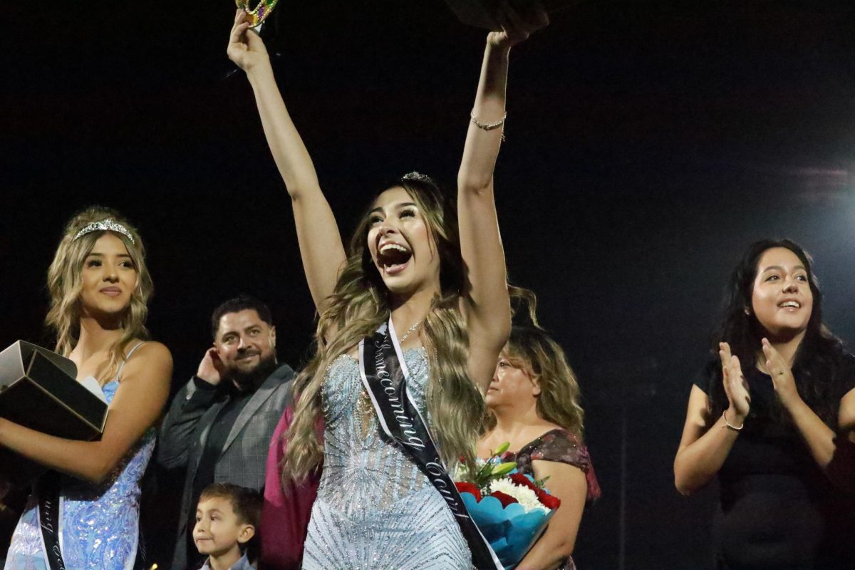 The surprised joy of winning Homecoming Queen erupts on Kassandra Romo's face as she is presented the winner's mask during the halftime show.