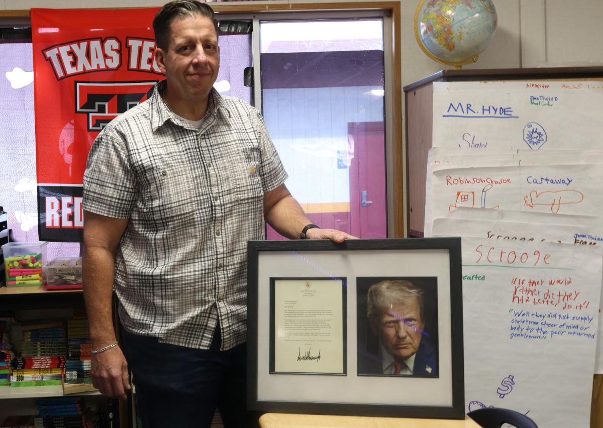 English teacher Chad Hackworth with a framed copy of the letter his class received from the White House in mid Jan. 2026.
