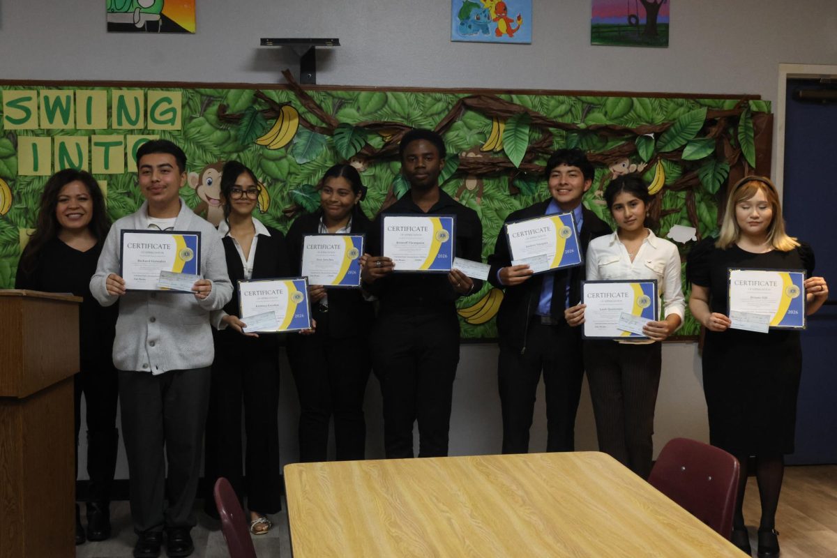 AP Language and Composition teacher at Colton High, Lucy Leyva stands next to her current and former students with pride after the competition