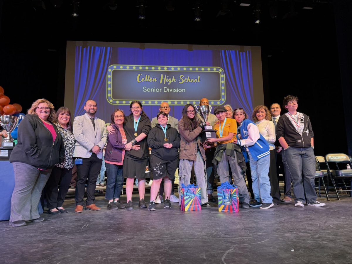Colton's 2025-2026 district Science Fair gold medallists are joined on stage by family and district administration to celebrate their success. Gold medallists include: Lexxie Ayala, Addy Lemos, Cosmo Mosher-Dominguez, and Diana Pham.
