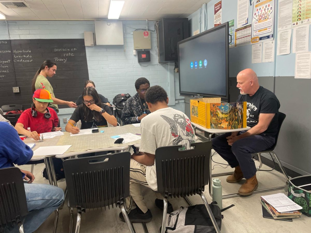 Welding instructor Chris Barta dons the role of Dungeon Master in a game of Dungeons & Dragons with the CHS club students.
