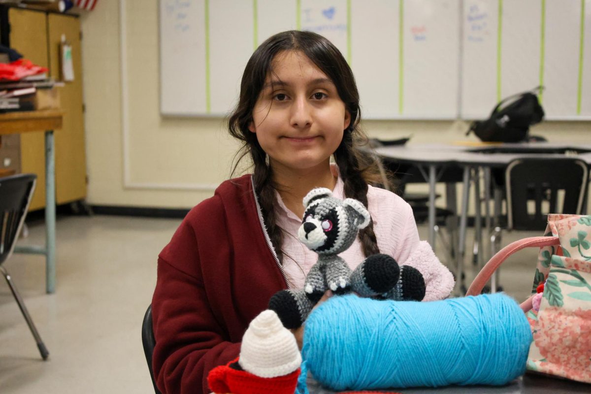 Daniela Castañeda shows off her cuddly raccoon creation. She is starting her own business selling these crocheted creatures.